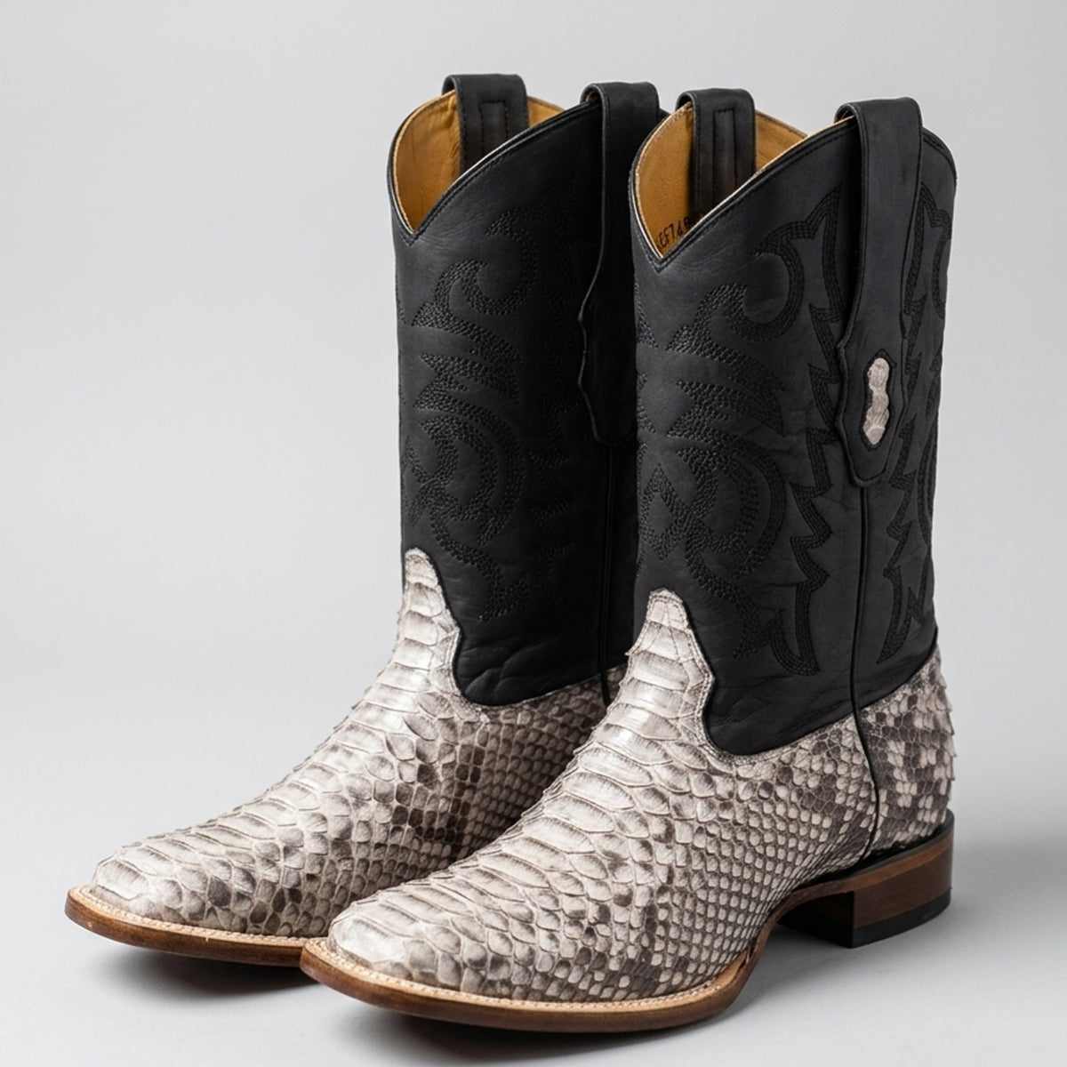 Los Altos men's western cowboy boots featuring a natural black and white python snakeskin foot, a stitched black leather shaft, and a modern square toe.