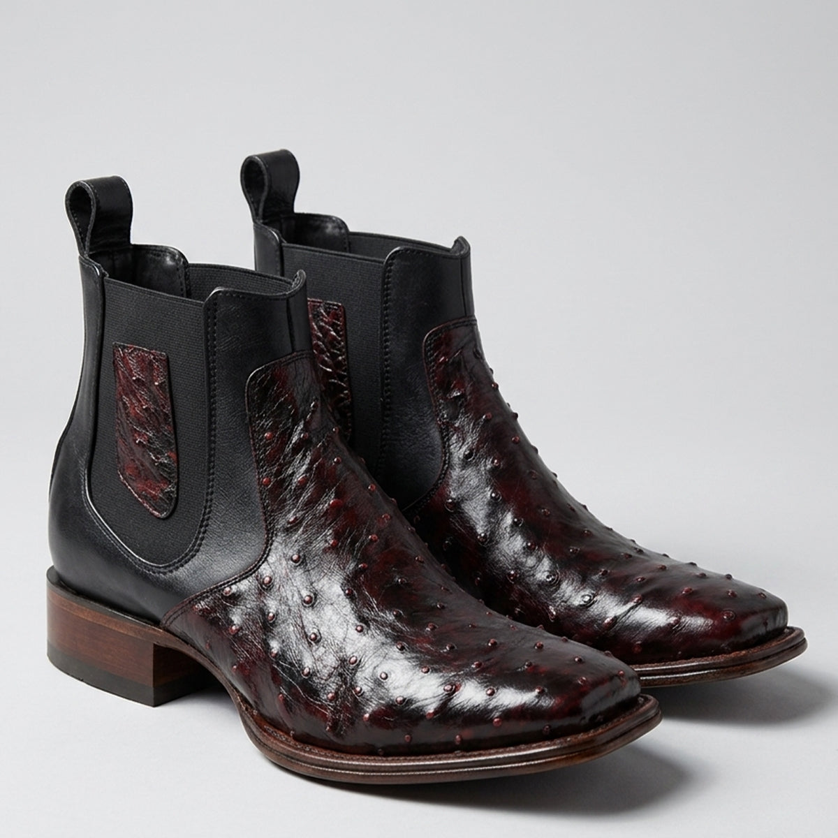 A pair Los Altos men's black cherry ankle ostrich square toe boots.