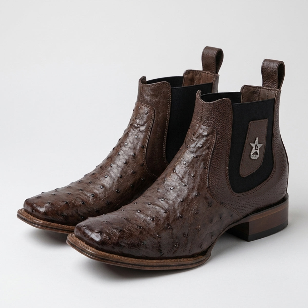 Los Altos men's brown genuine full quill ostrich leather Chelsea ankle boots featuring a square toe, black elastic side goring, and a silver metal star accent.