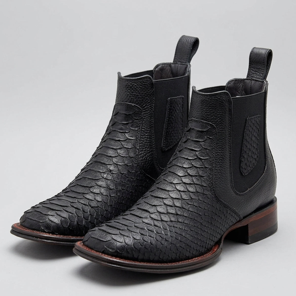 Los Altos men's black genuine python leather Chelsea western boots featuring a matte textured snakeskin pattern, black elastic side goring, and a square toe.