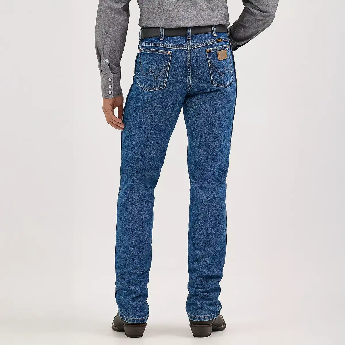 Rear view of Wrangler Men's Cowboy Cut slim fit jeans showing the Neolite leather patch and signature 'W' back pocket stitching.