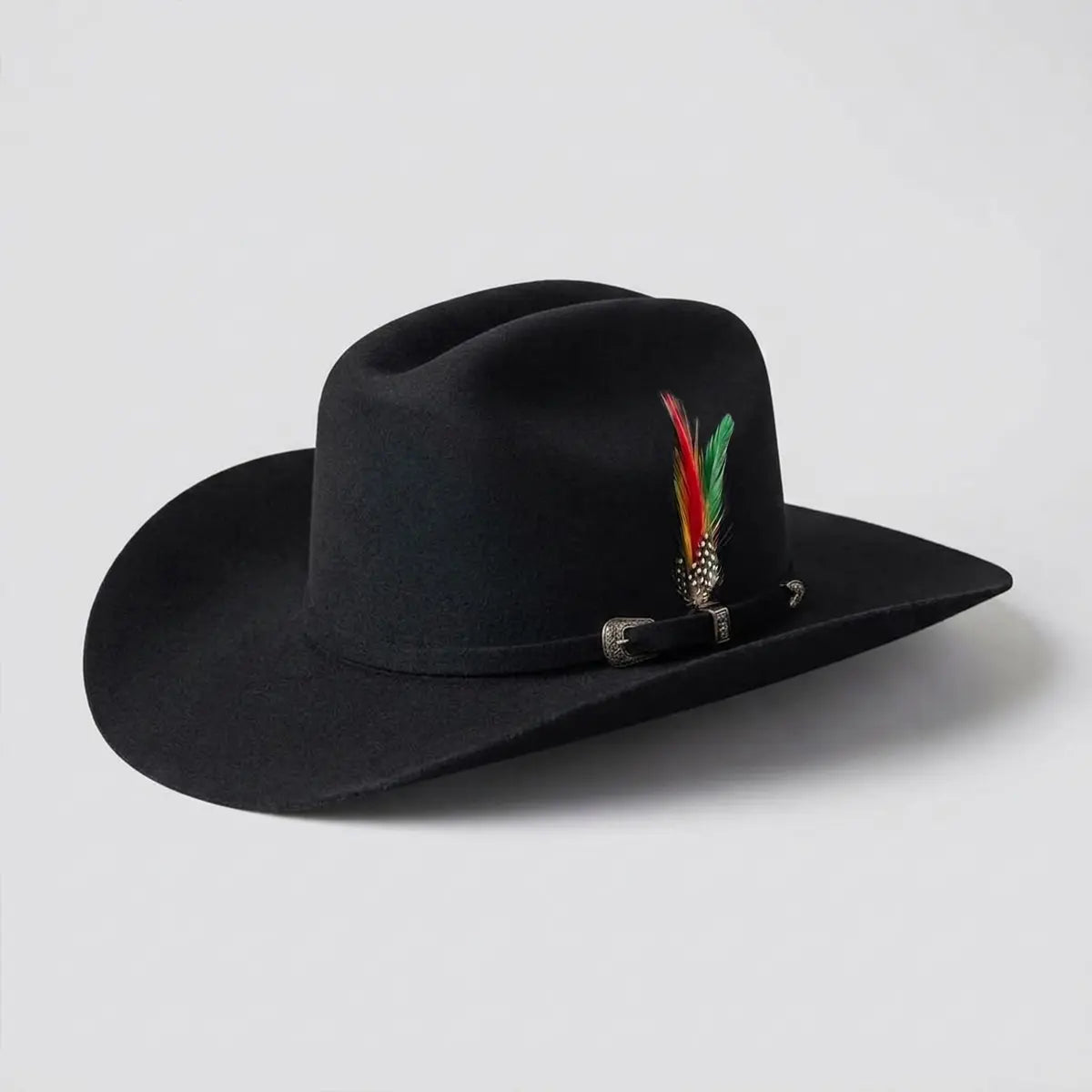 Three-quarter studio profile view of the Abolengo 100X black wool blend cowboy hat displaying the Cattleman crown crease, Sinaloa brim shape, silver buckle set, and feather accent.