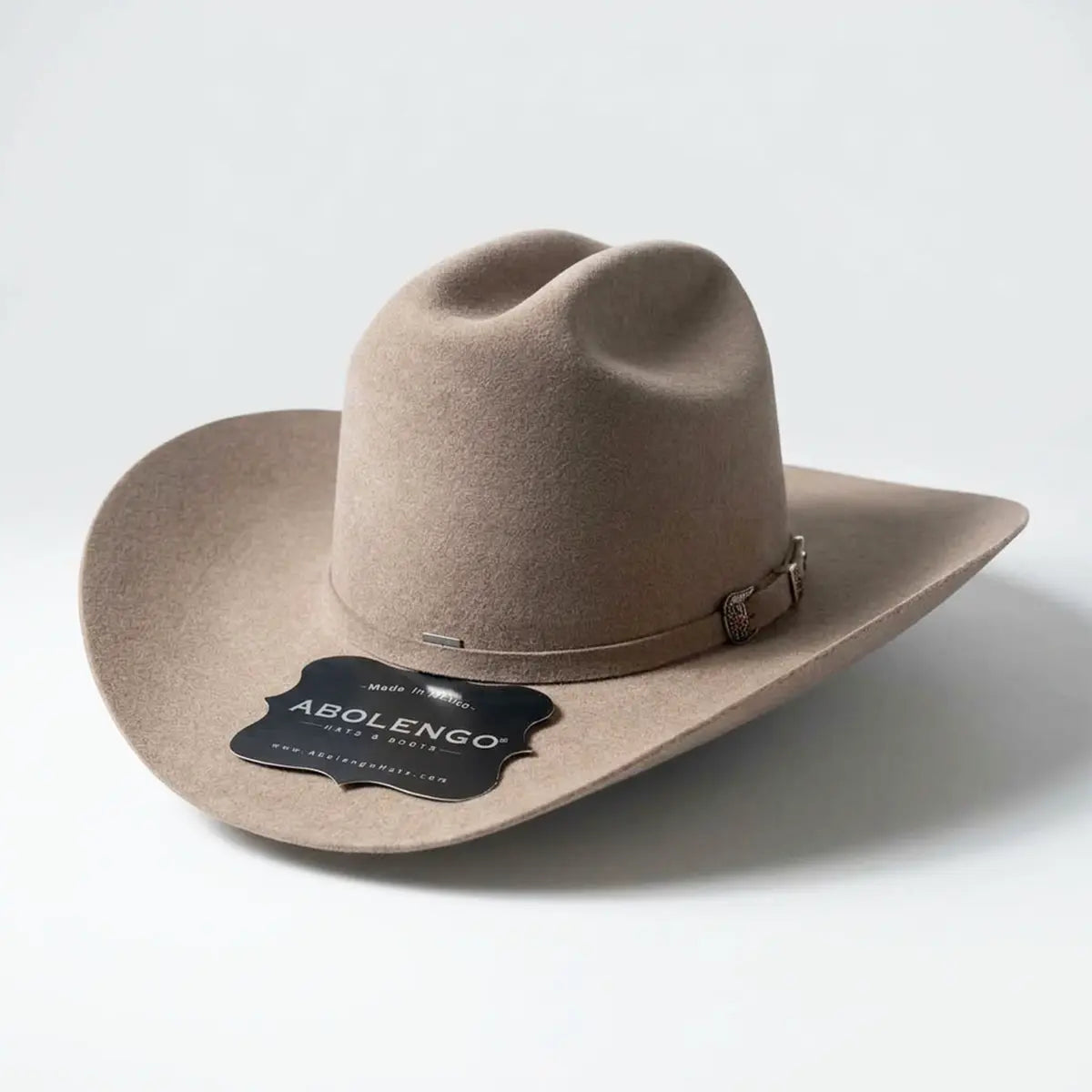 Three-quarter studio profile view of the Abolengo 1000X natural taupe rabbit fur felt cowboy hat displaying the Sinaloa style brim, Cattleman crown, and silver buckle set.