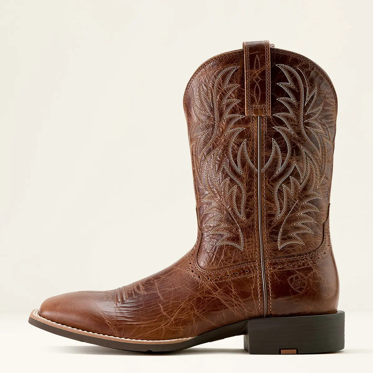 Lateral profile studio view of the Ariat men's Sport Western dark tan boot showing the embossed Ariat logo near the heel counter and Horseman heel.