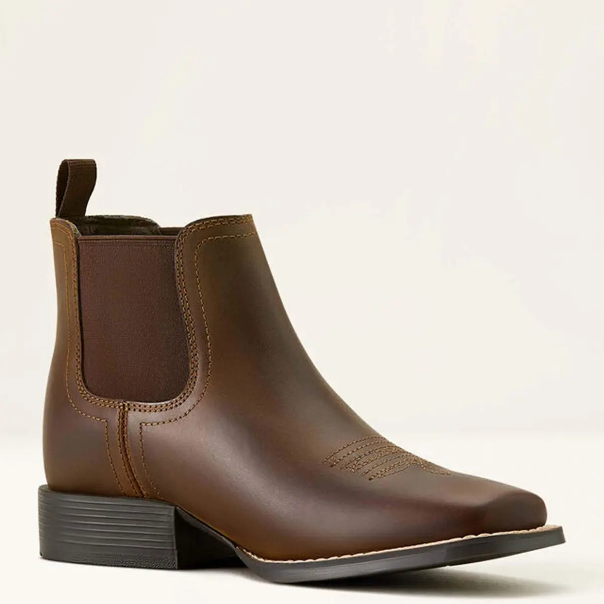 Three-quarter studio shot of the Ariat Kids' Booker Chelsea boot in distressed brown leather showing the wide square toe, elastic goring, and 1.125" heel.