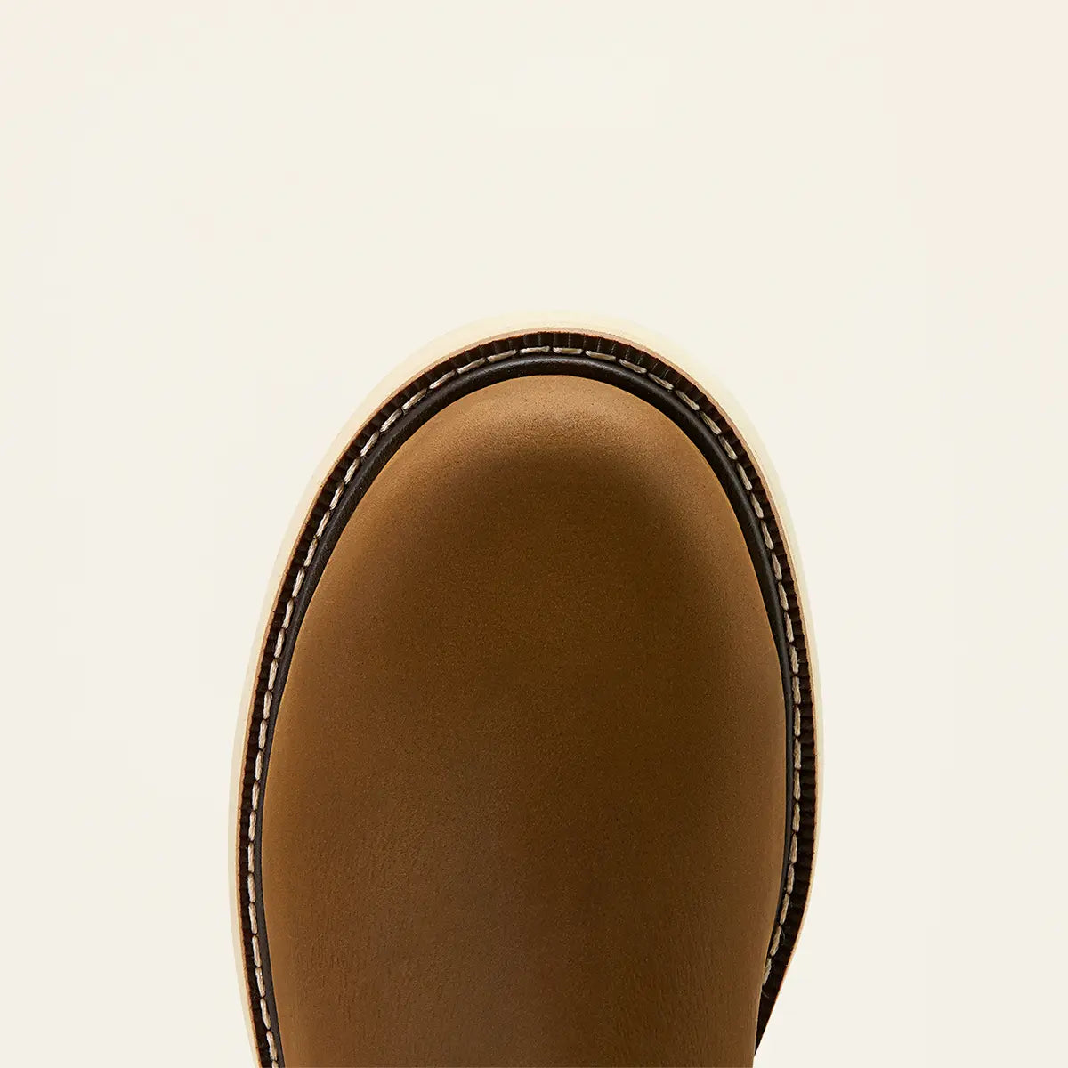 Top-down close-up shot of the round safety toe construction and heavy-duty double-welt stitching on the Ariat Rebar Wedge boot.