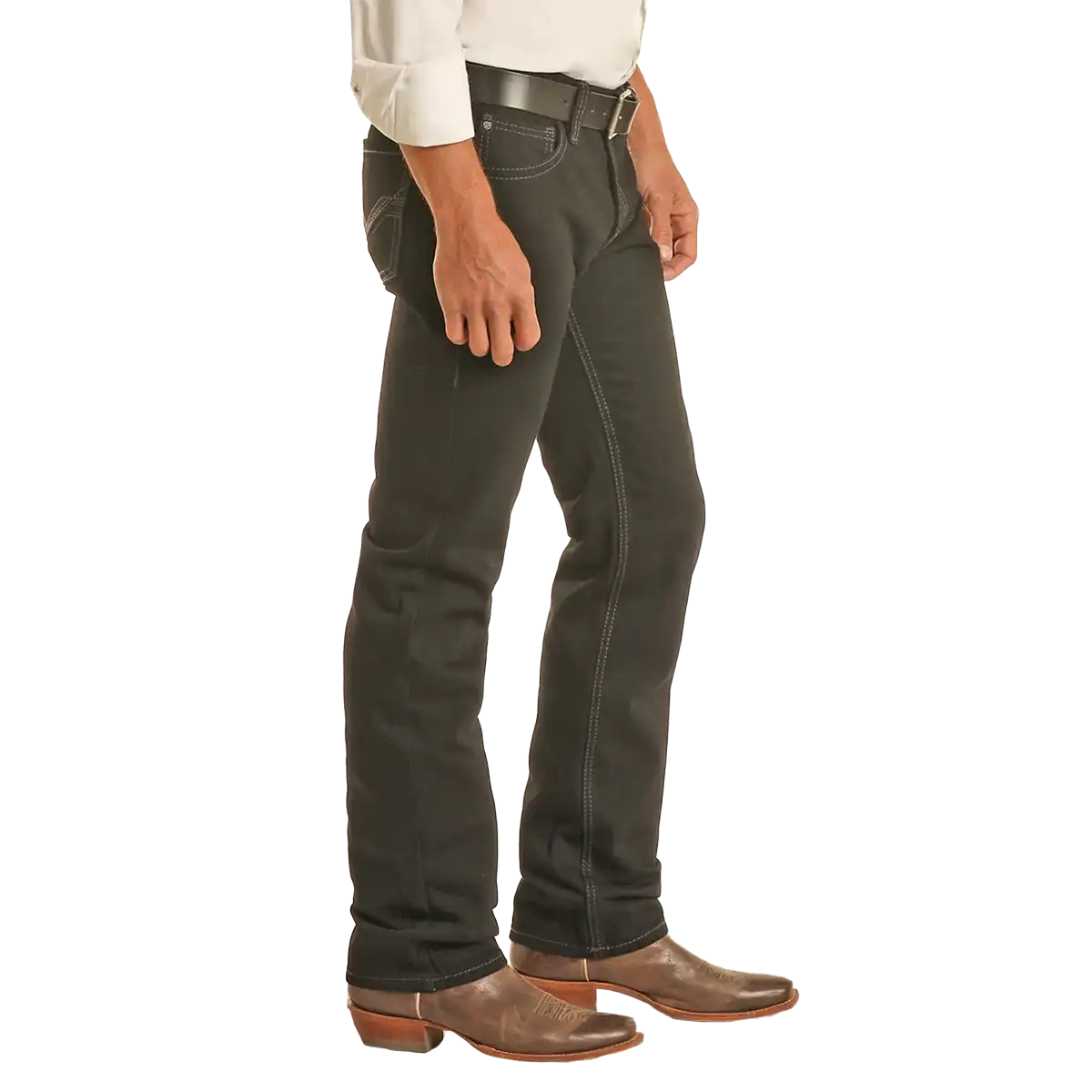 Studio side view of a man wearing Rock & Roll Denim Revolver black slim straight jeans with Western belt and boots.