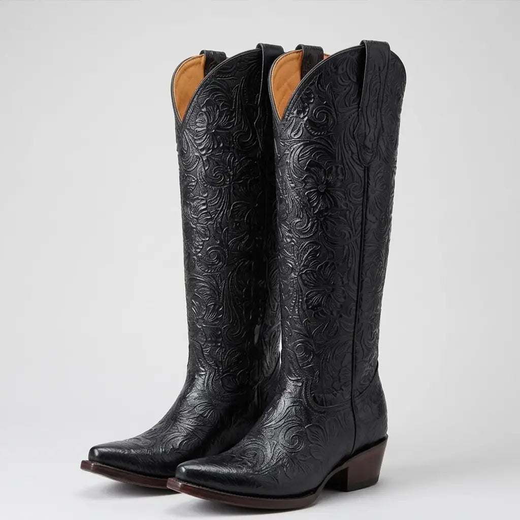 Studio pair shot of the Lirac 17-inch tall black tooled cowgirl boots displaying the high-rise silhouette and intricate floral tooling.