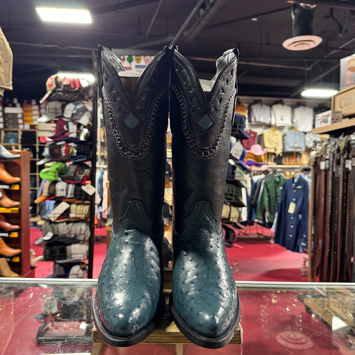 Pair of blue ostrich western boots on display.