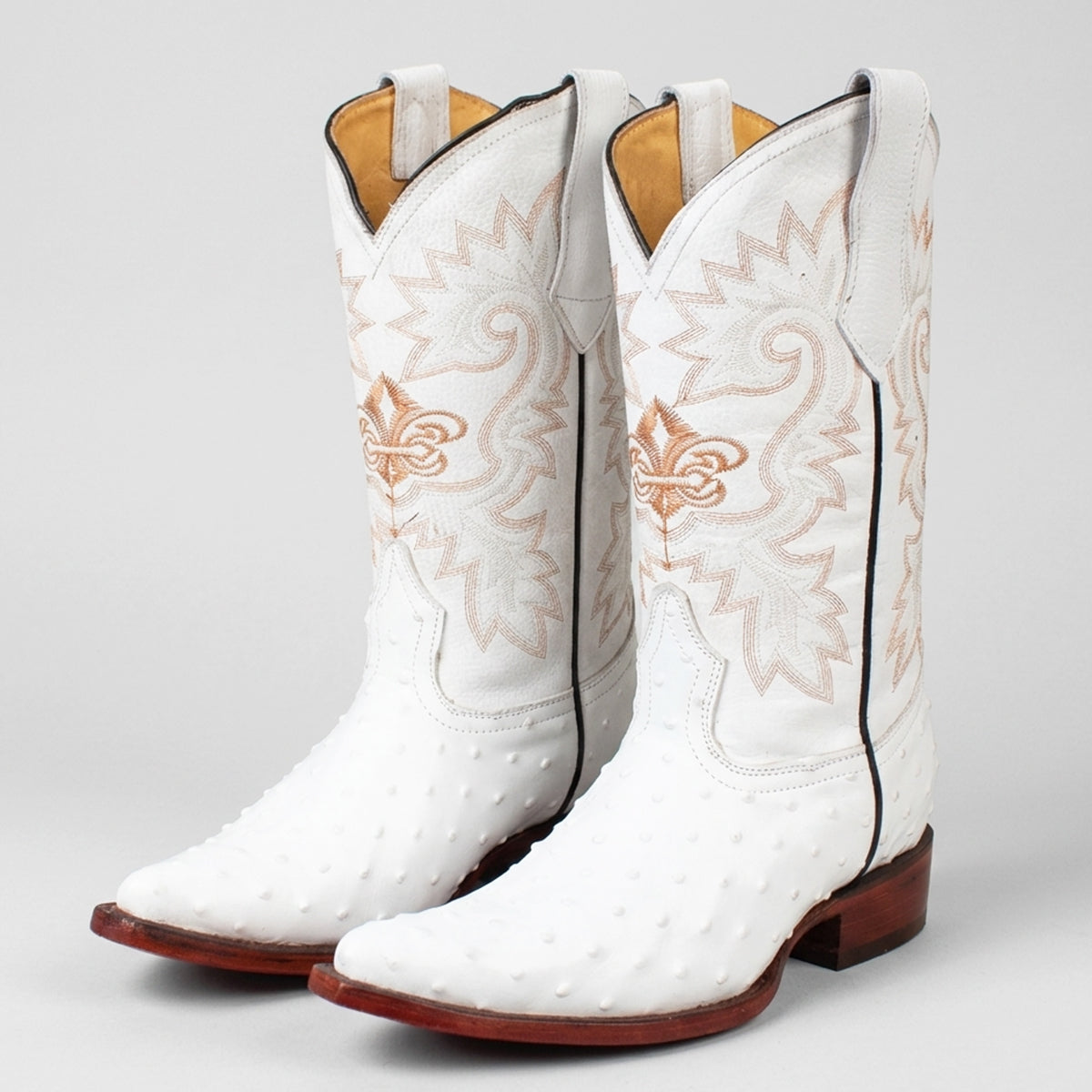 Carreta Men's white ostrich print cowboy boots featuring a 2X pointed toe, white leather shaft with tan Western embroidery, and leather sole.