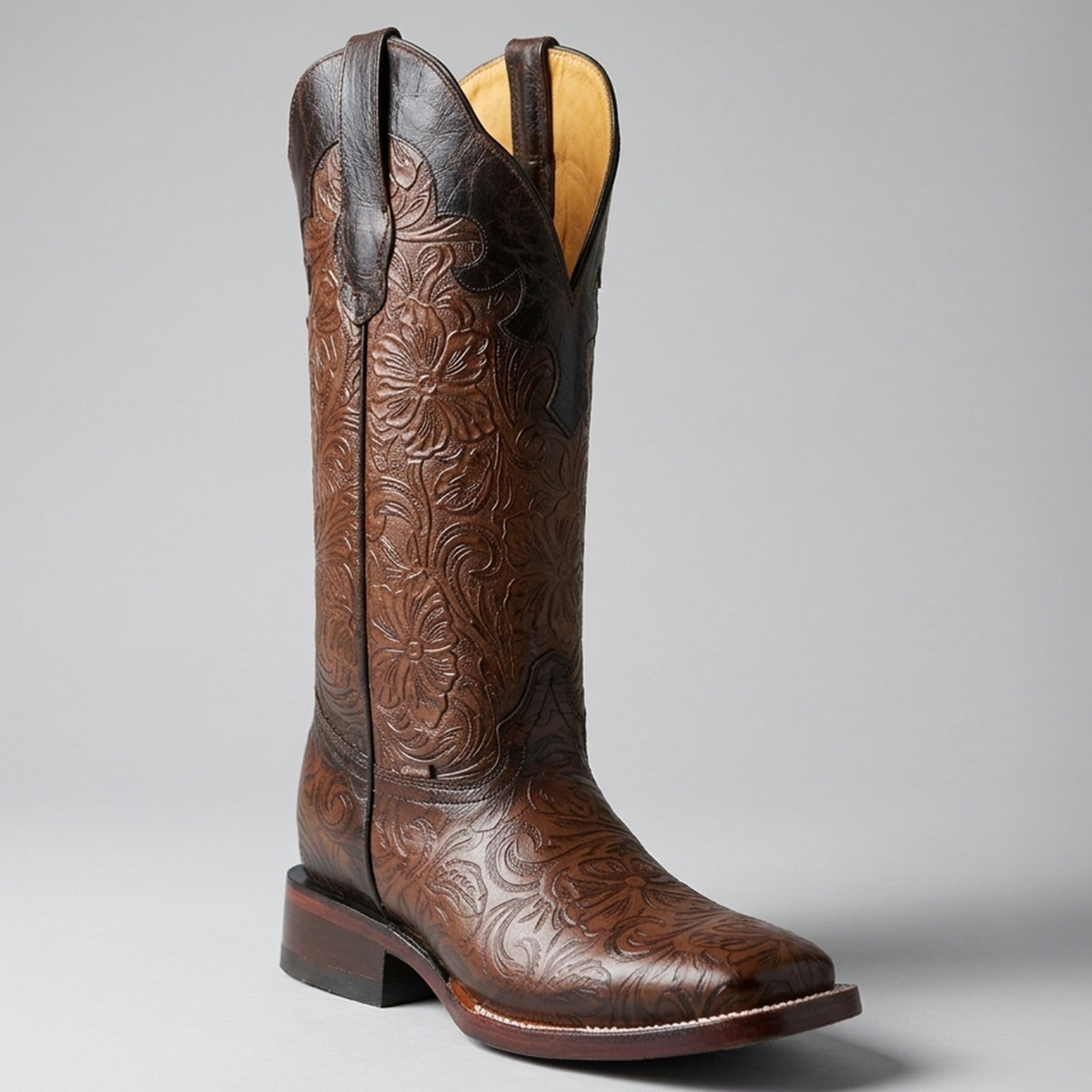 Botas Doble R women's rich brown hand-tooled print square toe Western boots featuring an allover floral embossed pattern, dark collar, and leather sole.
