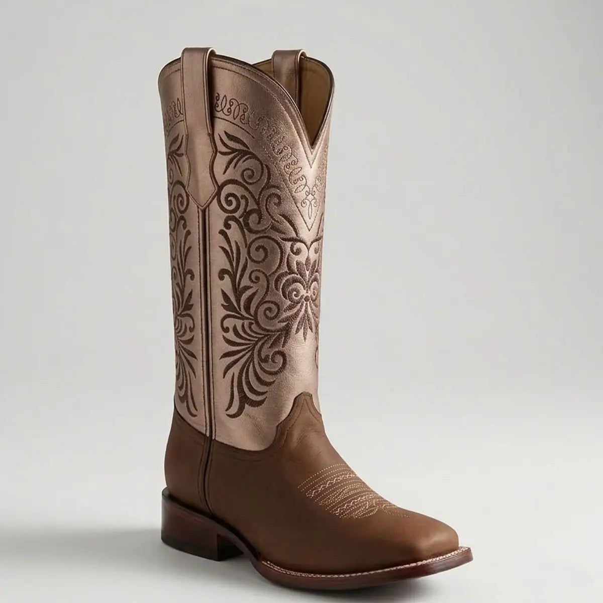 Single Botas Doble R Ivanna Crazy Cafe cowgirl boot in a studio setting, showcasing the brown leather square toe with pink stitching and a metallic shaft featuring elaborate dark floral embroidery.