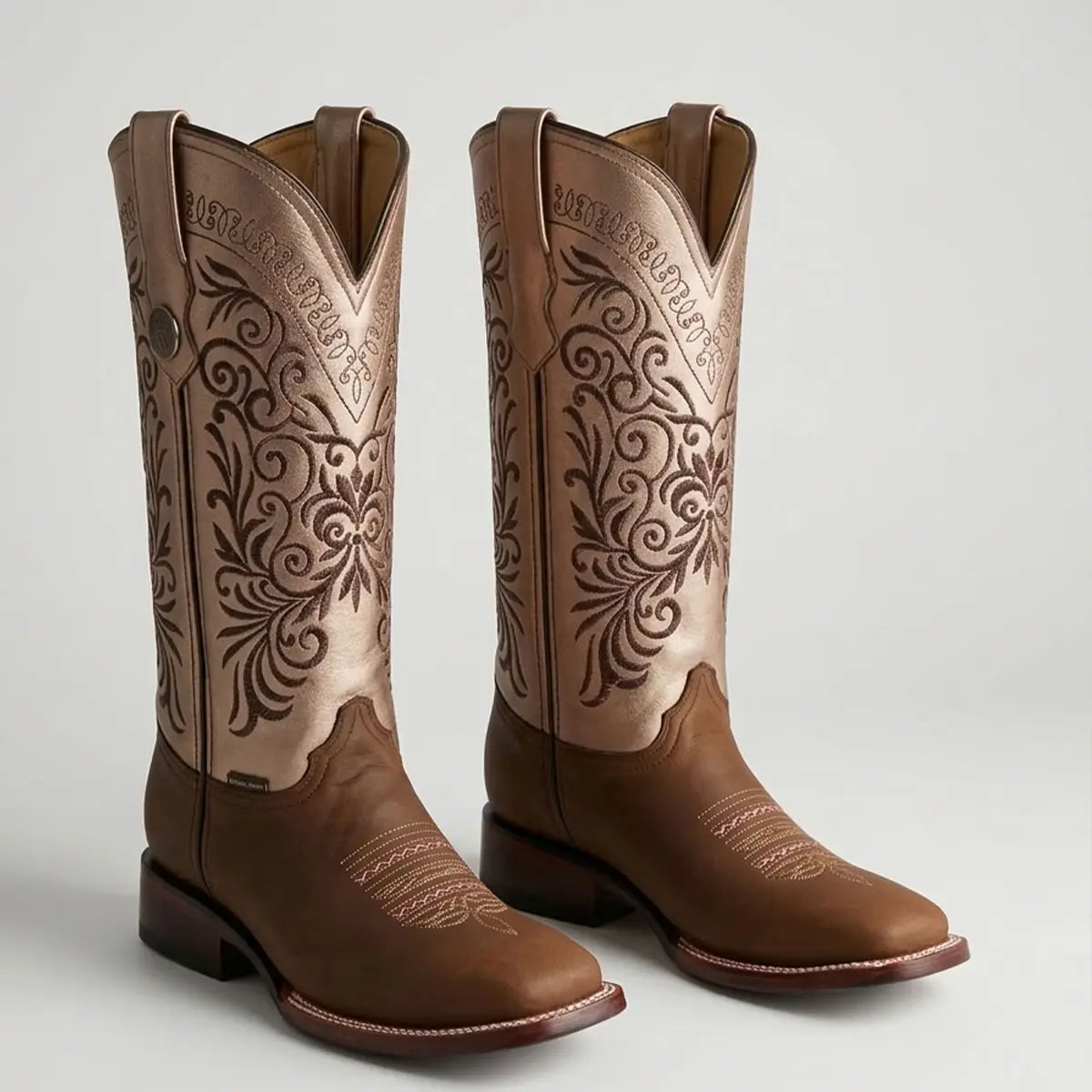 Pair of women's Botas Doble R Ivanna Crazy Cafe boots displayed against a light background, highlighting the contrast between the smooth brown leather vamp and the tall metallic embroidered shaft.