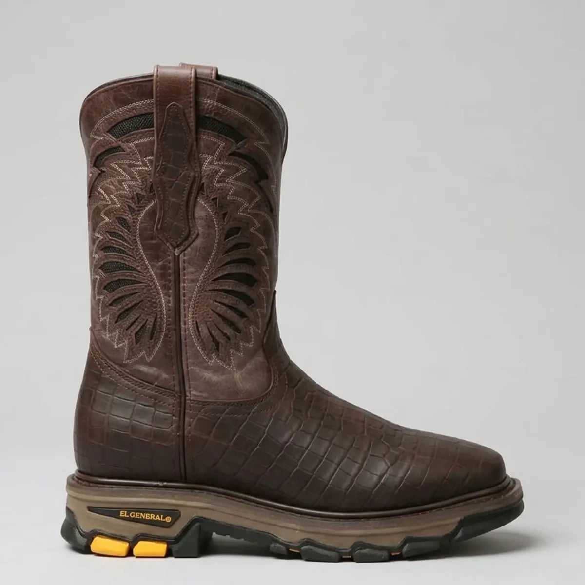 Side profile studio view of the El General men's chocolate brown caiman print work boot highlighting the heavy-duty tractor outsole, square toe profile, and leather pull tabs.