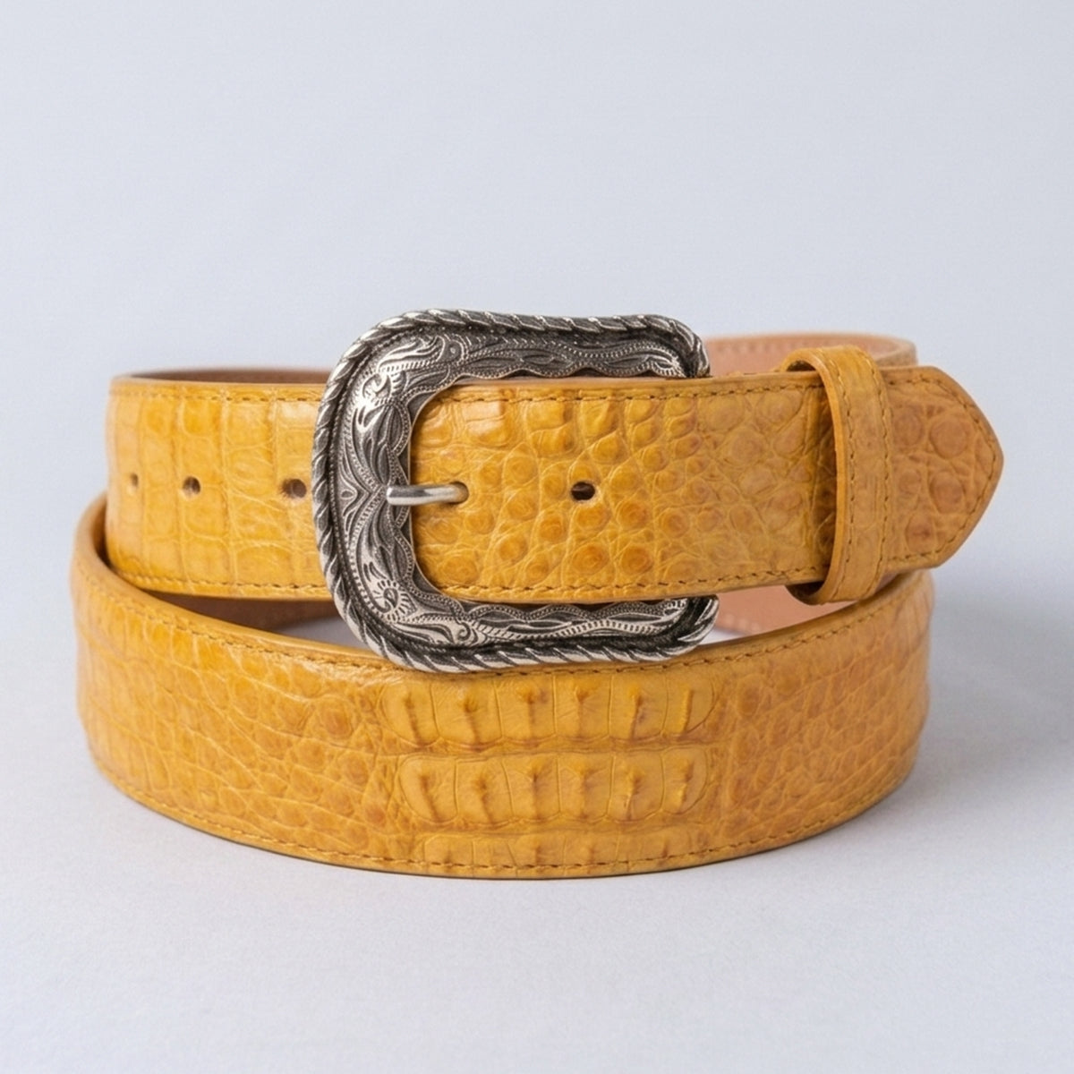 Los Altos men's buttercup yellow caiman bellky leather belt with  silver-tone western-style buckle, shown on a light gray background.
