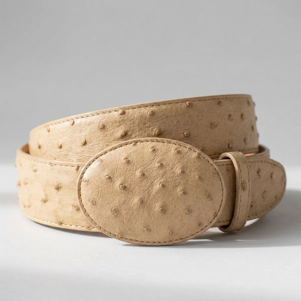 Los Altos men's oryx beige ostrich leather belt with a matching oval buckle.