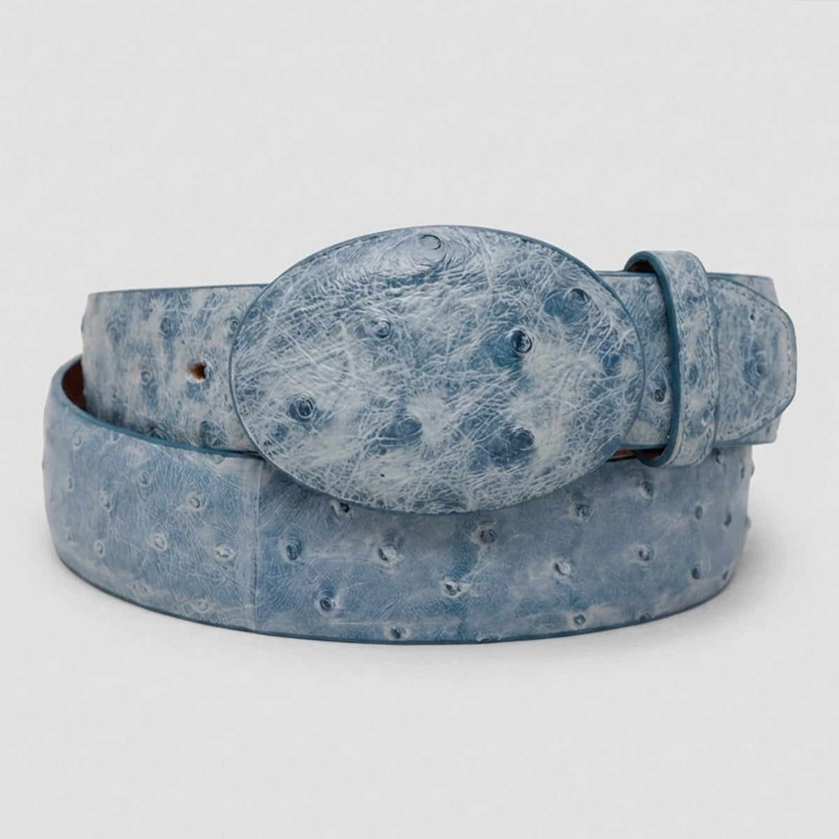 Los Altos men's light rustic blue full quill ostrich leather belt with a matching oval buckle, coiled on a light gray background.