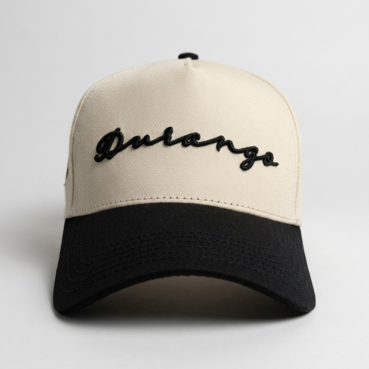 Durango signature baseball cap in a cream color with black brim.