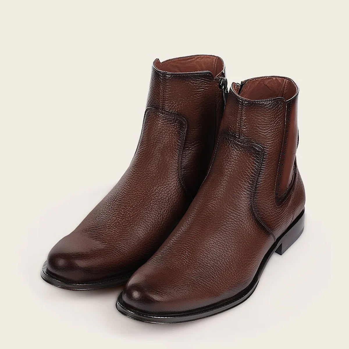 Pair of Cuadra men's brown deer leather Chelsea boots on a light beige background.