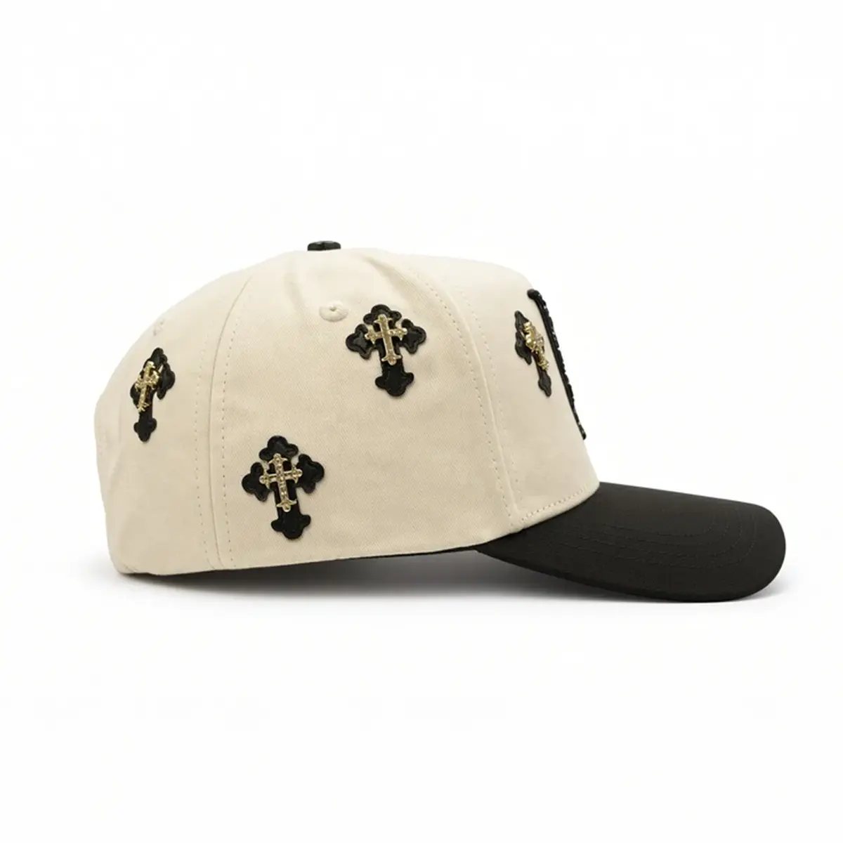 Right side view of the Klan Hats LA Chrome cap highlighting the profile shape, black visor, and cross details.
