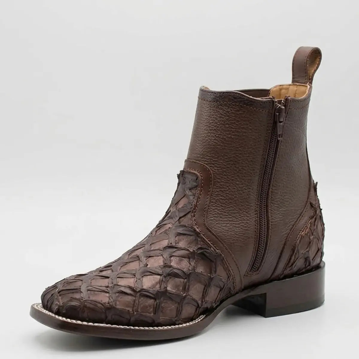 Inner side profile view of the Los Altos Cortez pirarucu boot displaying the functional side zipper closure, heel pull tab, and stacked leather heel.