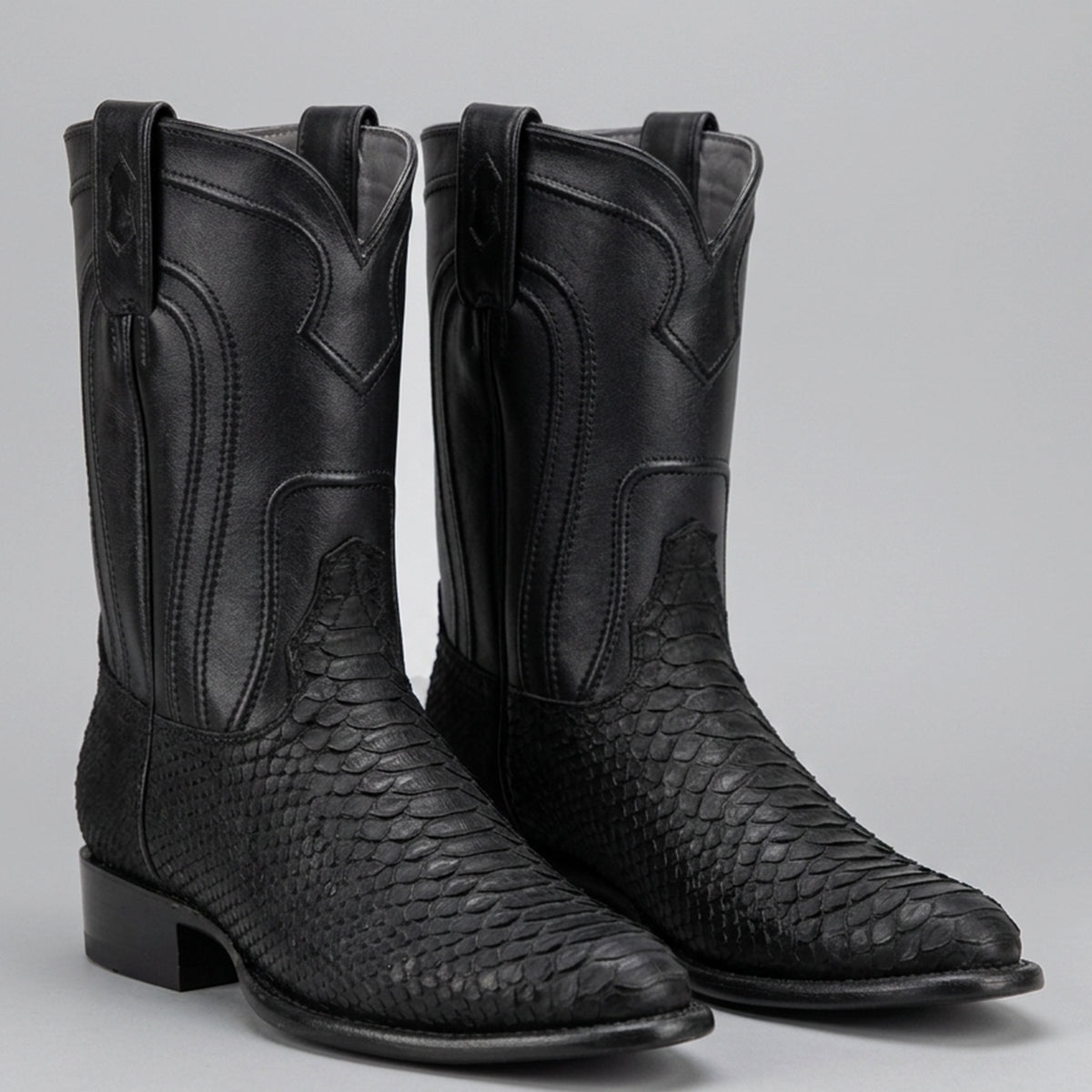 Los Altos men's western roper boots featuring a matte black suede python snakeskin foot, a smooth black leather shaft, a low block heel, and a round toe.