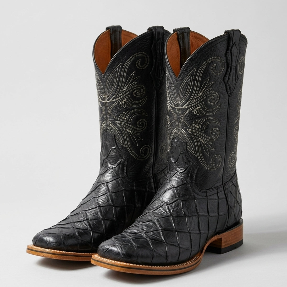 Men's black Pirarucu fish print square toe cowboy boots with detailed Western stitching on the upper shaft and a natural leather welt.
