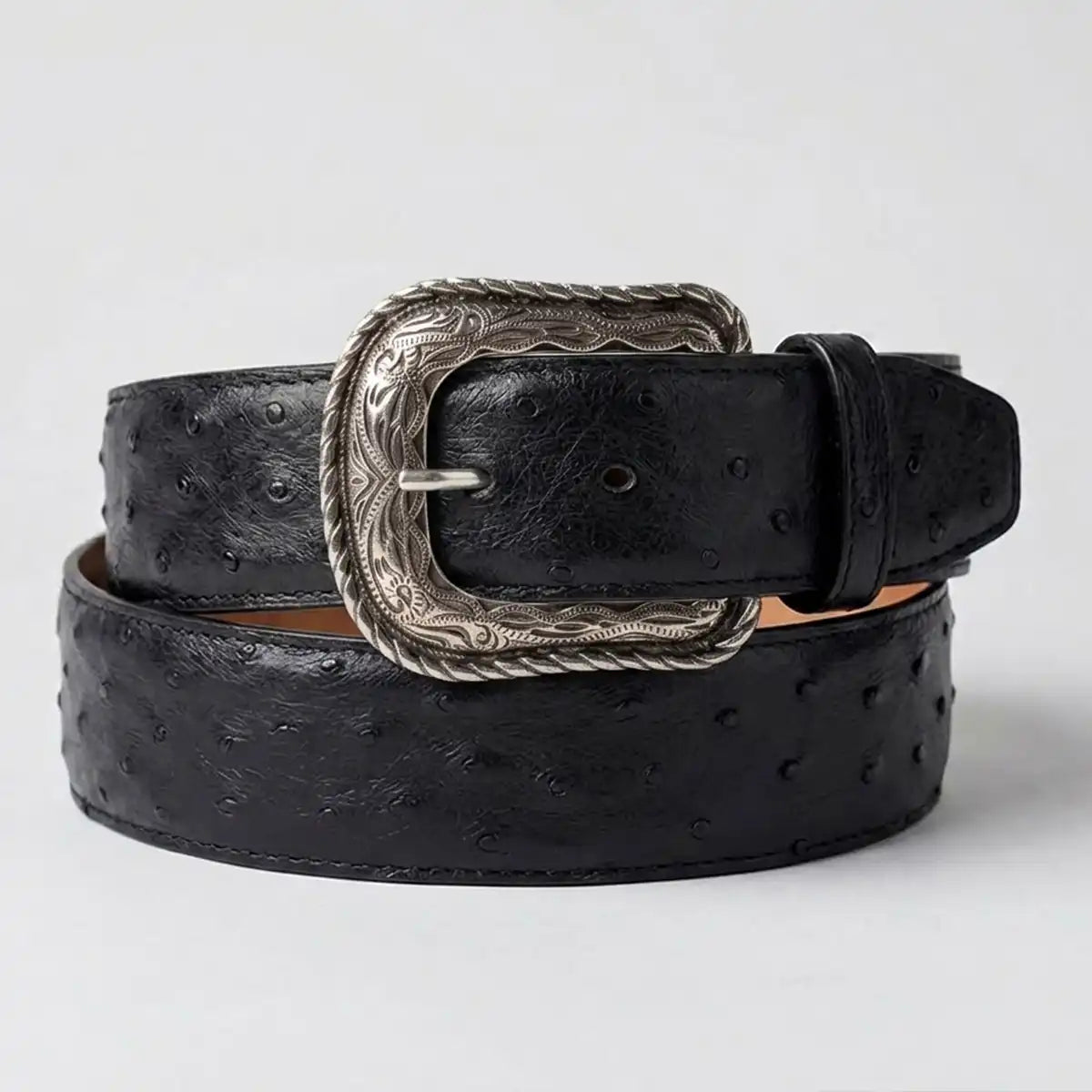 Los Altos men's black ostrich leather belt  with silver-tone western heel-bar buckle, coiled on a light gray background.