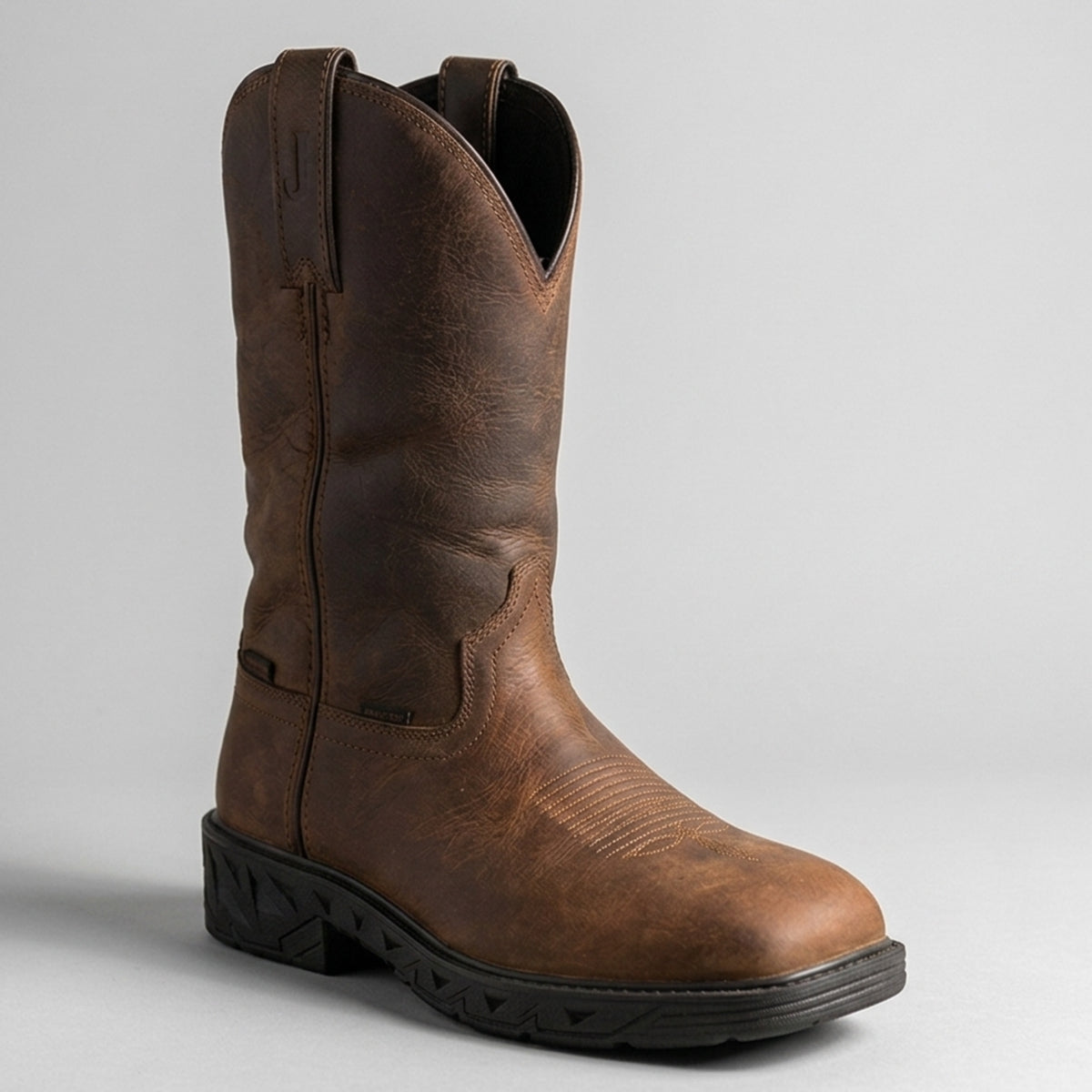 Justin Trencher 11-inch waterproof brown water buffalo leather steel toe work boot with square toe and slip-resistant rubber sole.