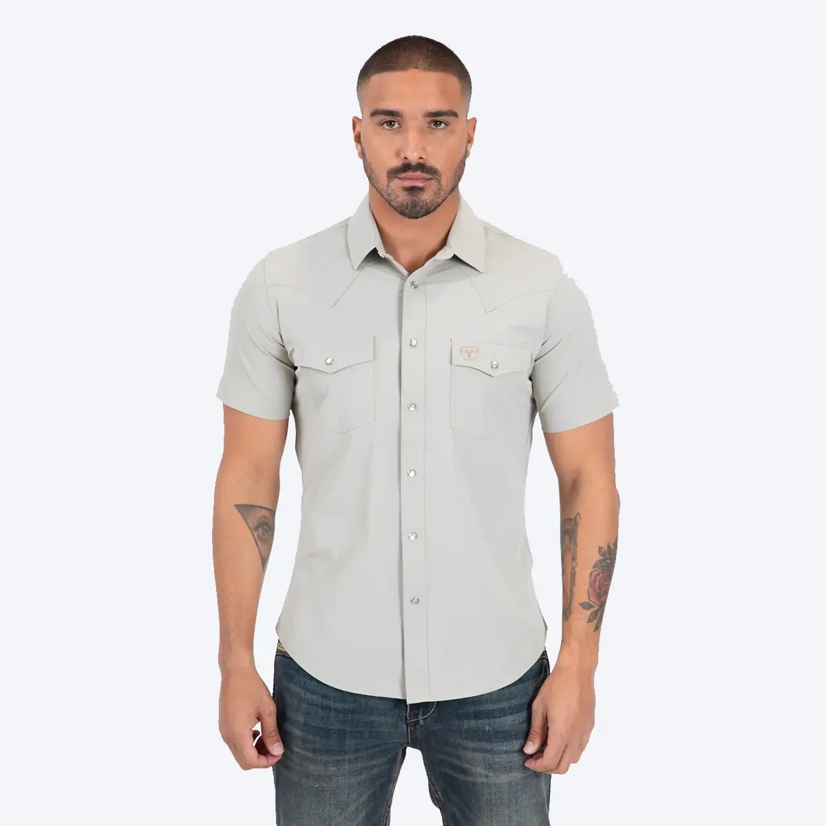 Front studio view of a male model wearing the Platini Men's Prewitt beige sand short sleeve Western performance snap shirt paired with blue denim jeans.