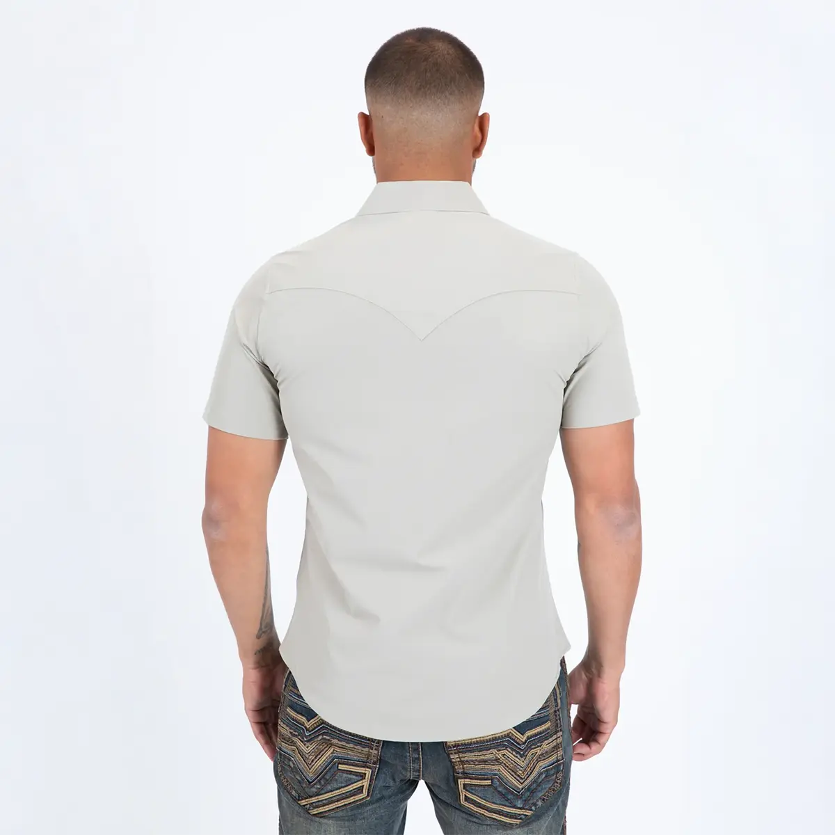 Back studio view of a male model wearing the Platini Prewitt beige performance shirt showing the pointed back Western yoke.