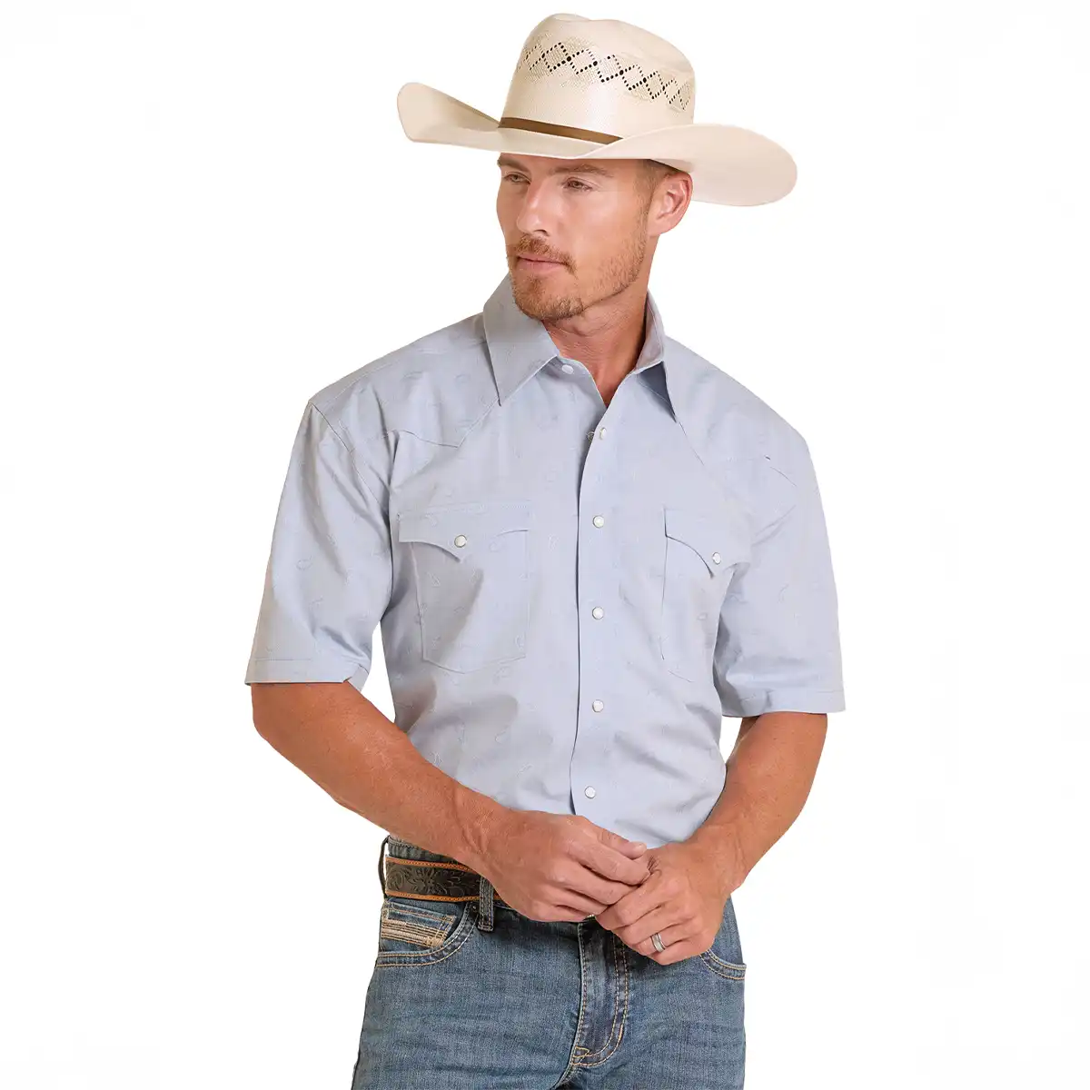 Model wearing the Panhandle Slim men's powder blue short sleeve snap shirt tucked into blue jeans with a cream cowboy hat and Western belt.