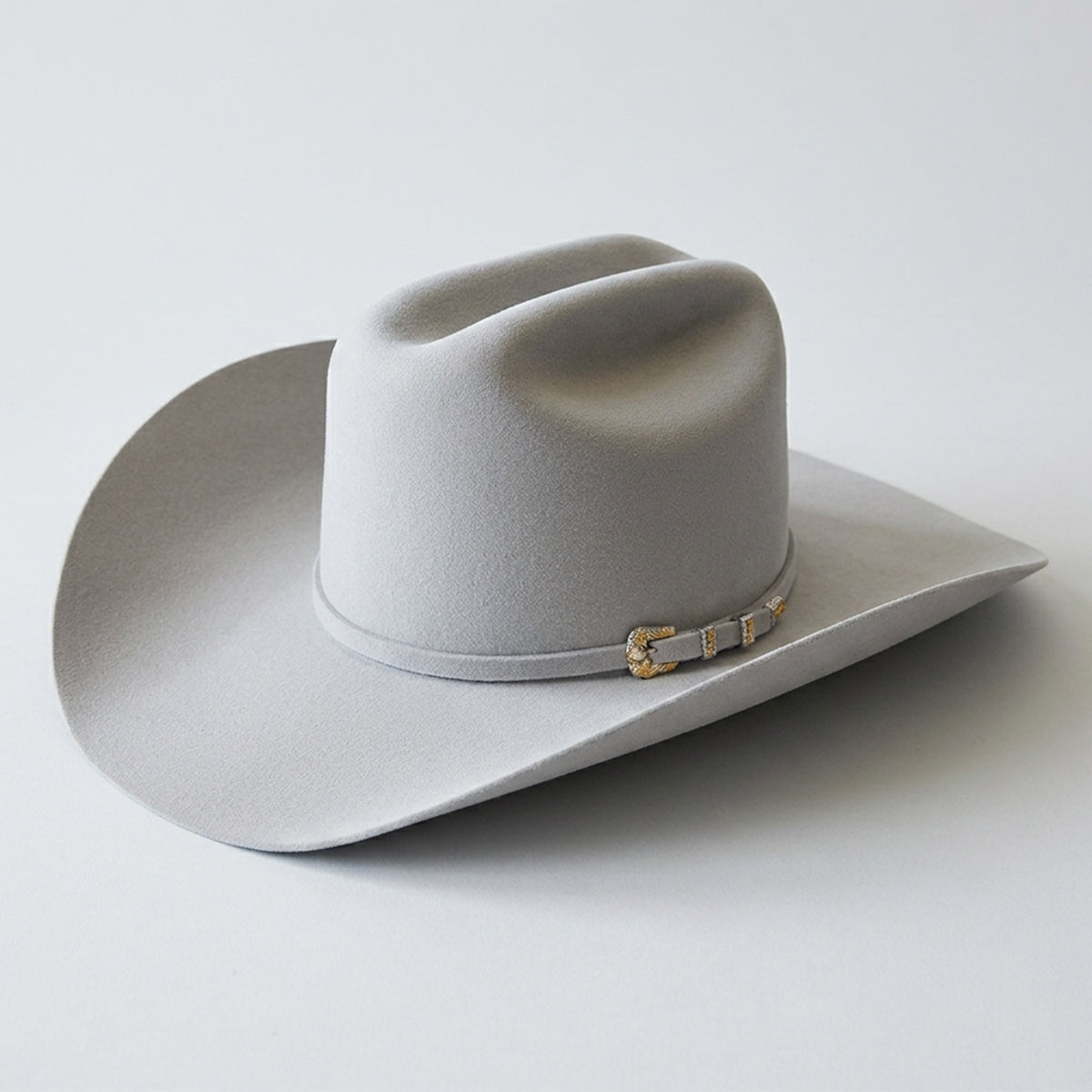 Serratelli cloud 6x beaver felt cowboy hat with a gold band on a light gray background.