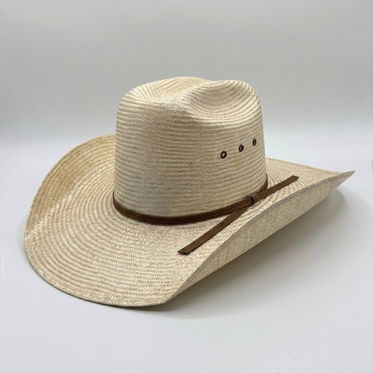 Abolengo Sisal Straw Minnick Crown Cowboy Hat featuring a natural woven finish, brown ribbon hat band, side eyelets, and a 4 1/4 inch curved brim.