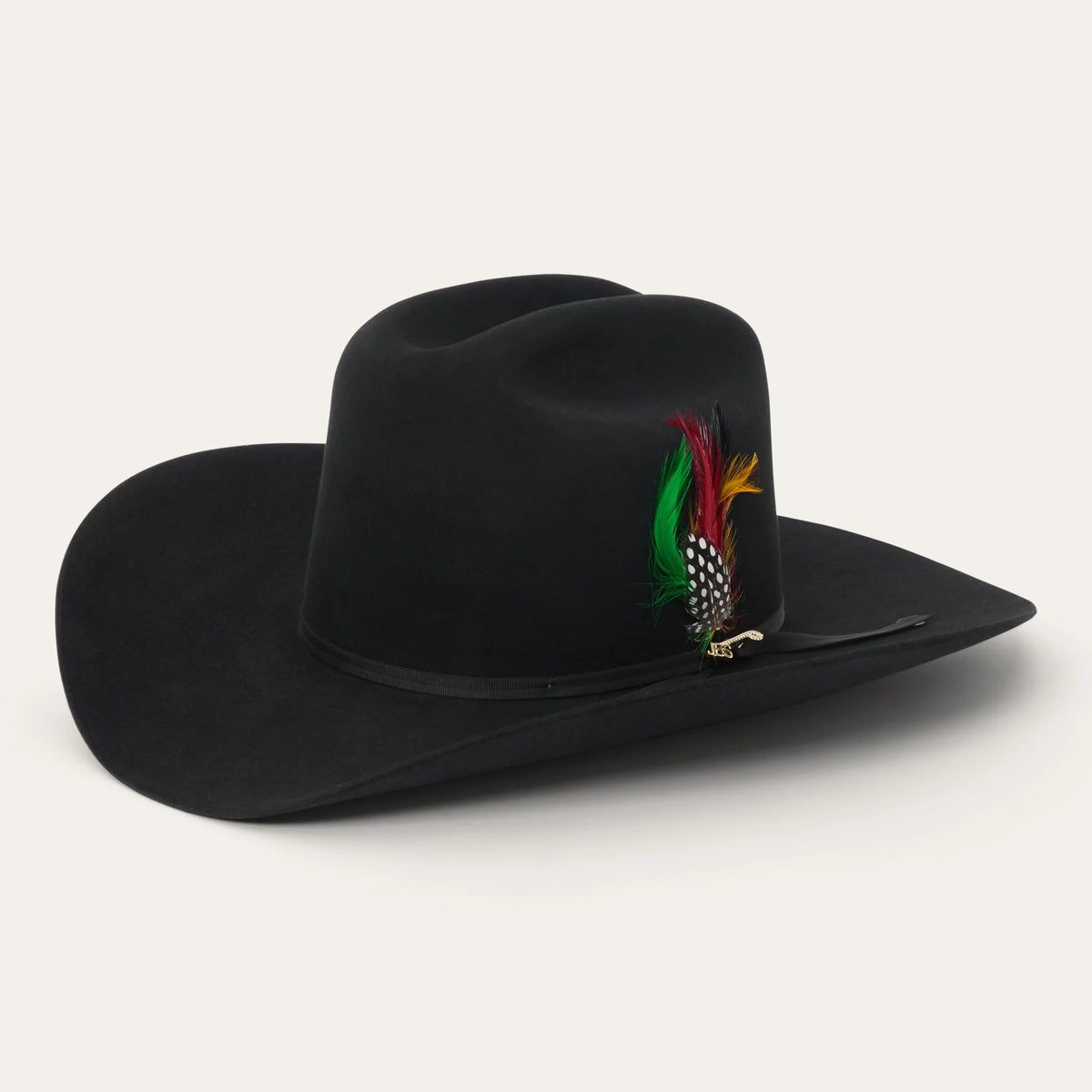 Angled studio view of the Stetson Rancher 30X black fur felt cowboy hat showcasing its 5-inch cattleman crown, 4-inch brim, and colorful feather accent.