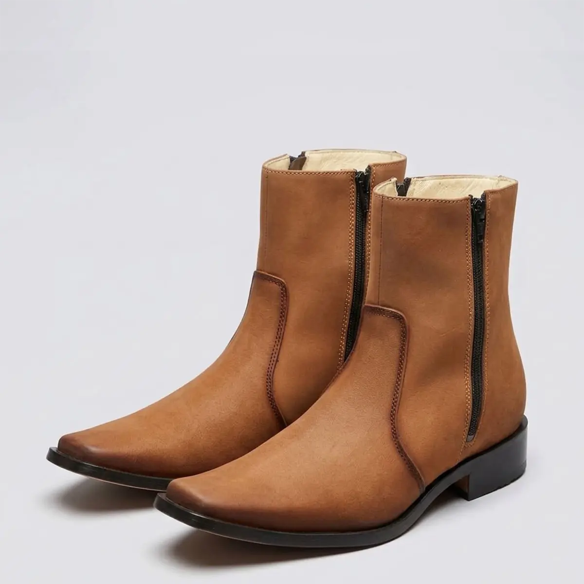 Studio pair shot of the El Besserro Men's Tan Nubuck leather zipper boots from a three-quarter angle highlighting the narrow square toe profile and matte finish.