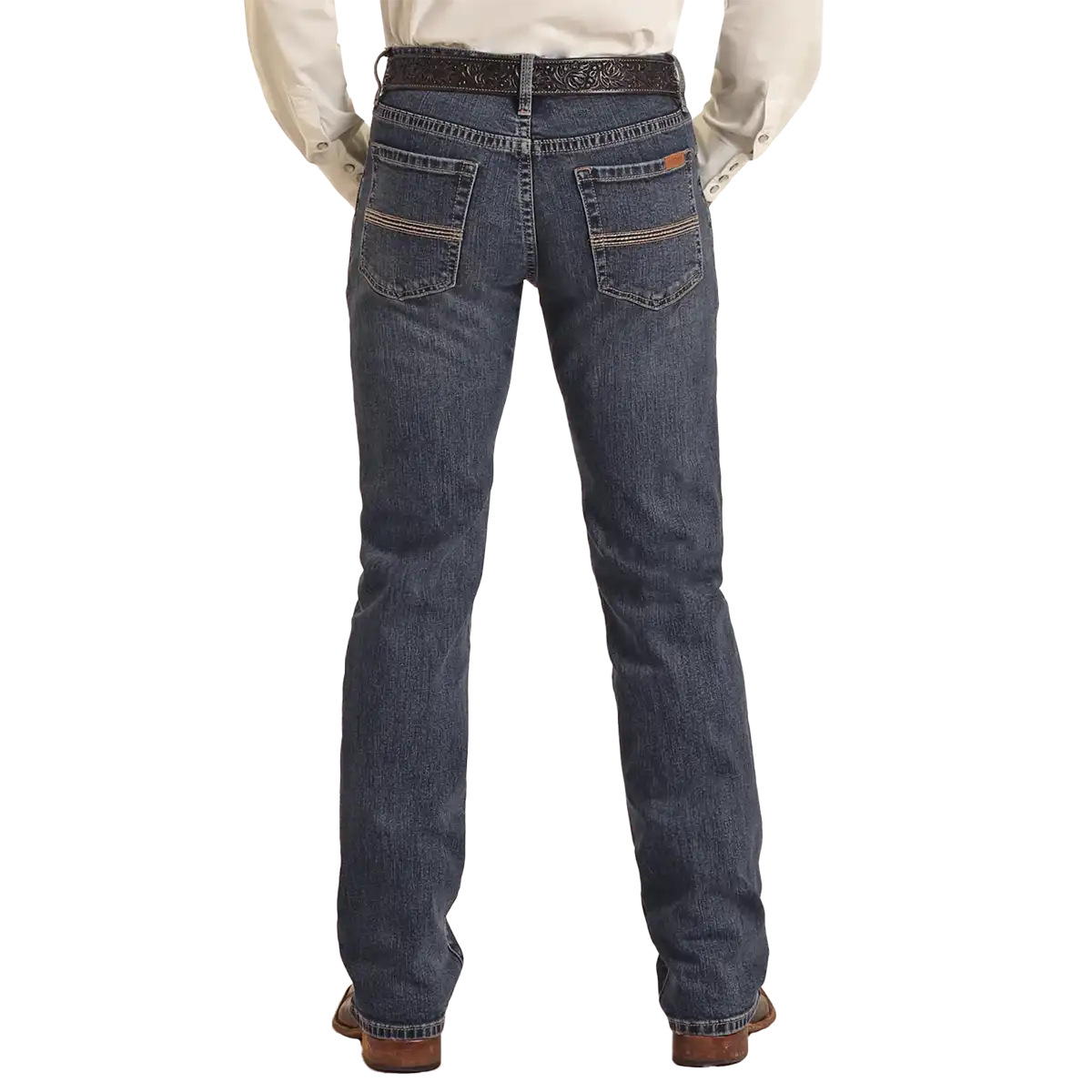 Studio back view of a man wearing Rock & Roll Denim Vintage '46 Revolver medium wash slim straight jeans with Western belt and boots.