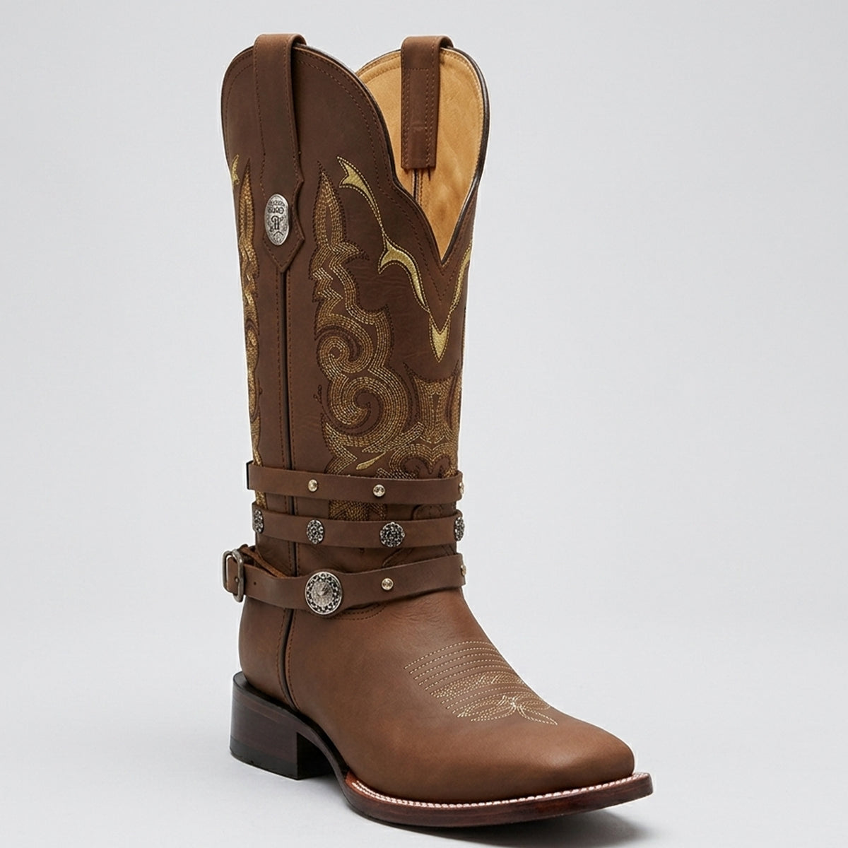 Botas Doble R Yoali women's brown leather square toe cowgirl boot featuring a removable studded harness strap, gold Western stitching, and block heel.