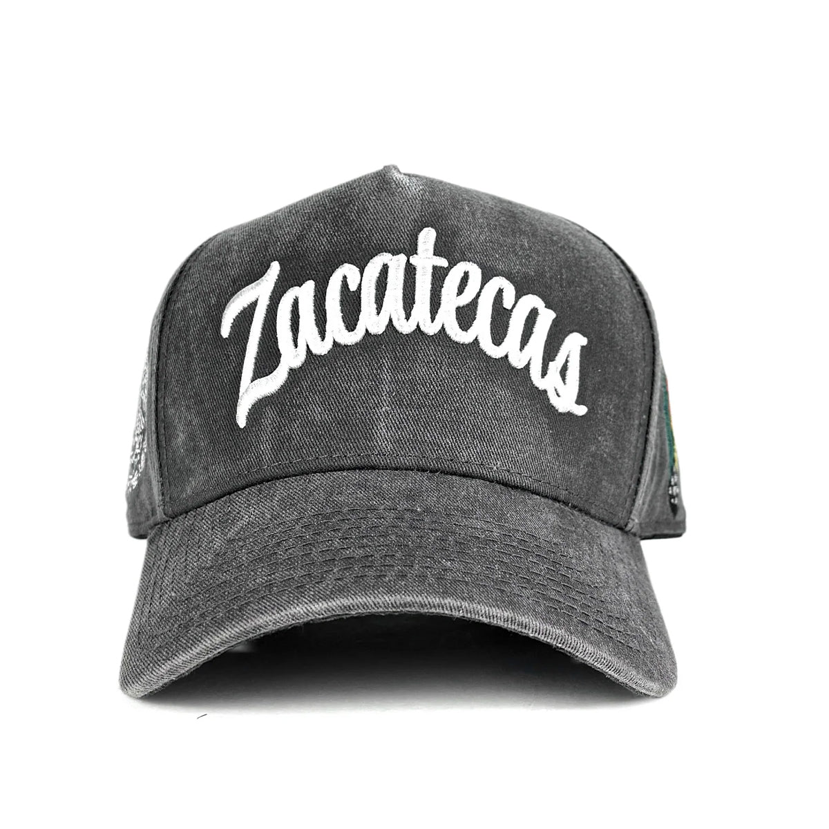 A dark gray acid-wash trucker cap featuring the word 'Zacatecas' embroidered in white script across the front panels, shown against a plain white background.