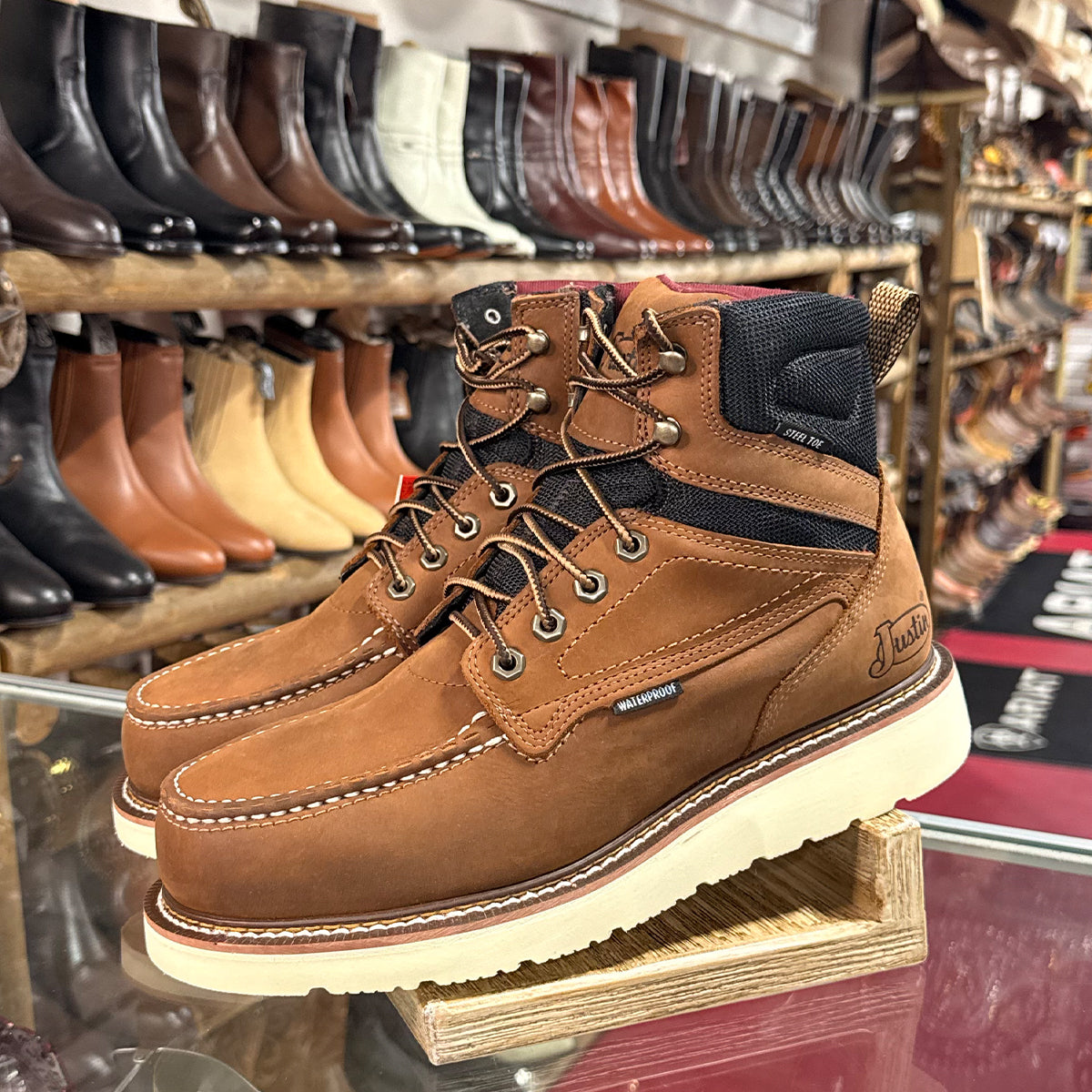 Justin brown leather steel toe work boots on display in a store.