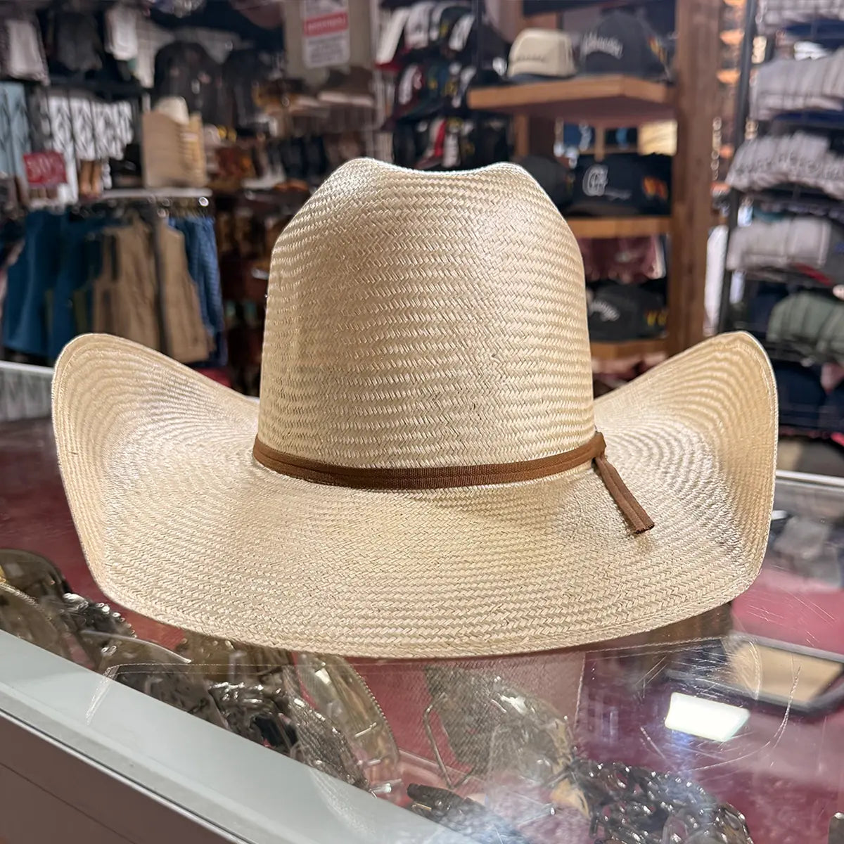 Direct front view of the Abolengo sisal straw hat showcasing the symmetrical curved brim shape, woven straw texture, and brown hatband.