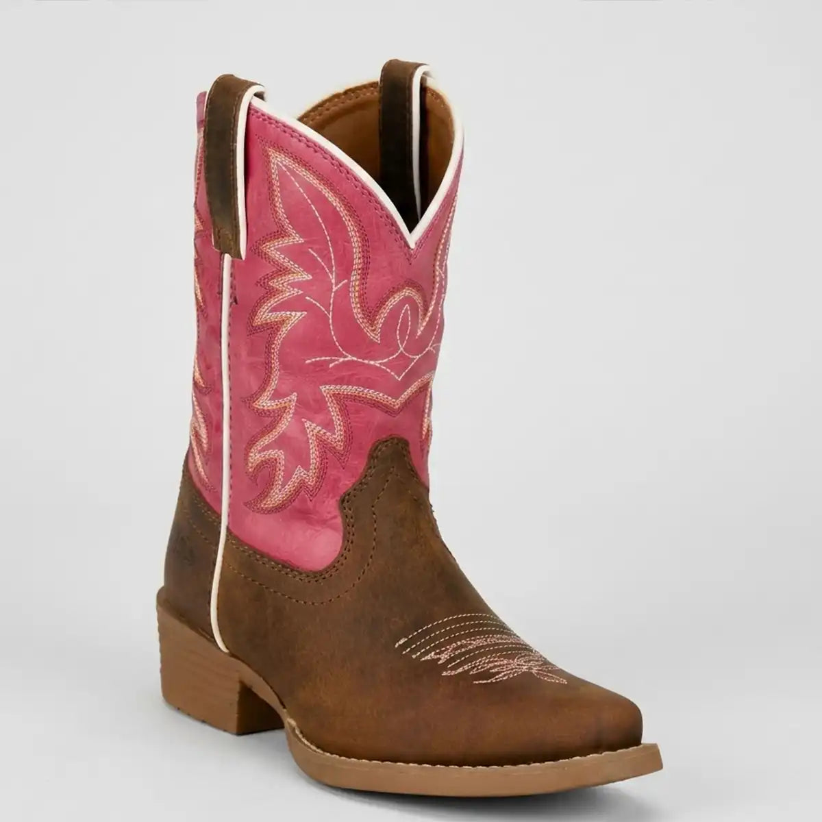 A single kids western cowboy boot with a brown leather body, a bright pink shaft, and light tan embroidery, shown against a light gray background.