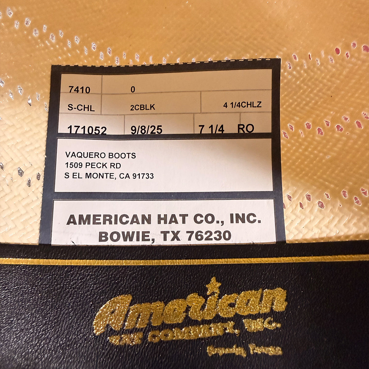 A close-up of a black leather sweatband label for American Hat Co., Inc.