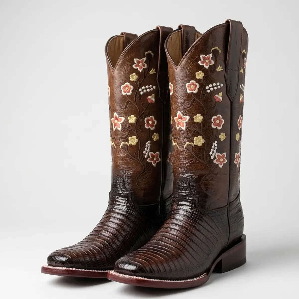 Pair studio view of the Abolengo brown lizard print cowgirl boots highlighting the multi-colored floral embroidery and Goodyear welt stitching on the square toe.