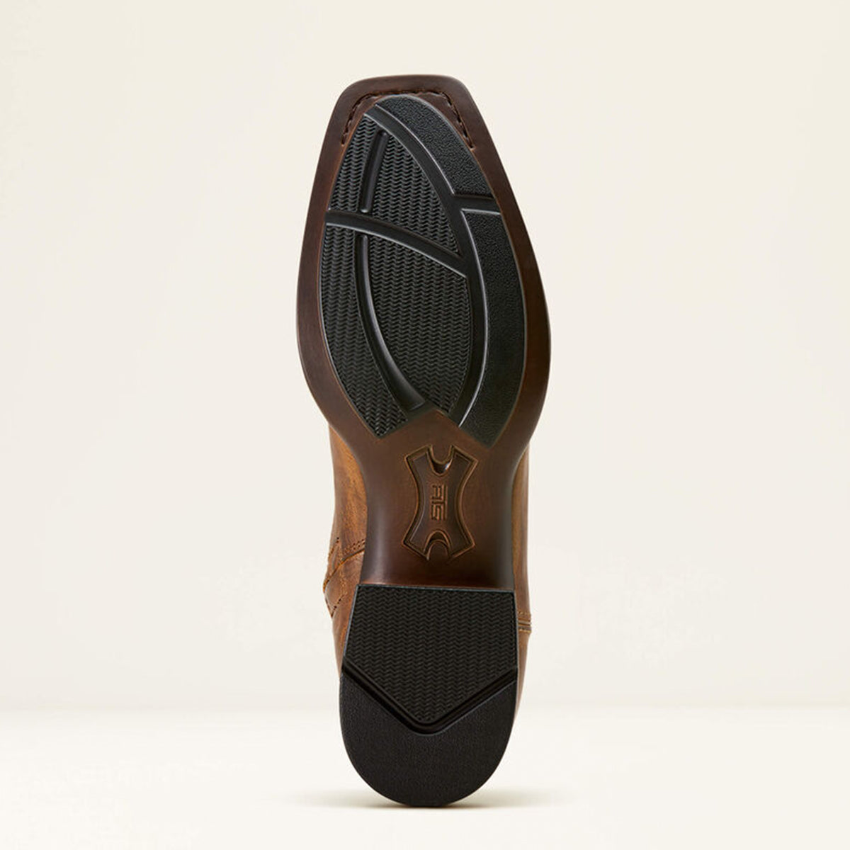 Ariat rubber outsole on a beige background.