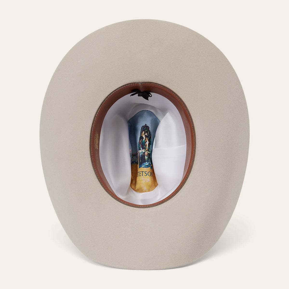 Beige cowboy hat with a brown band featuring Stetson satin liner on a white background.