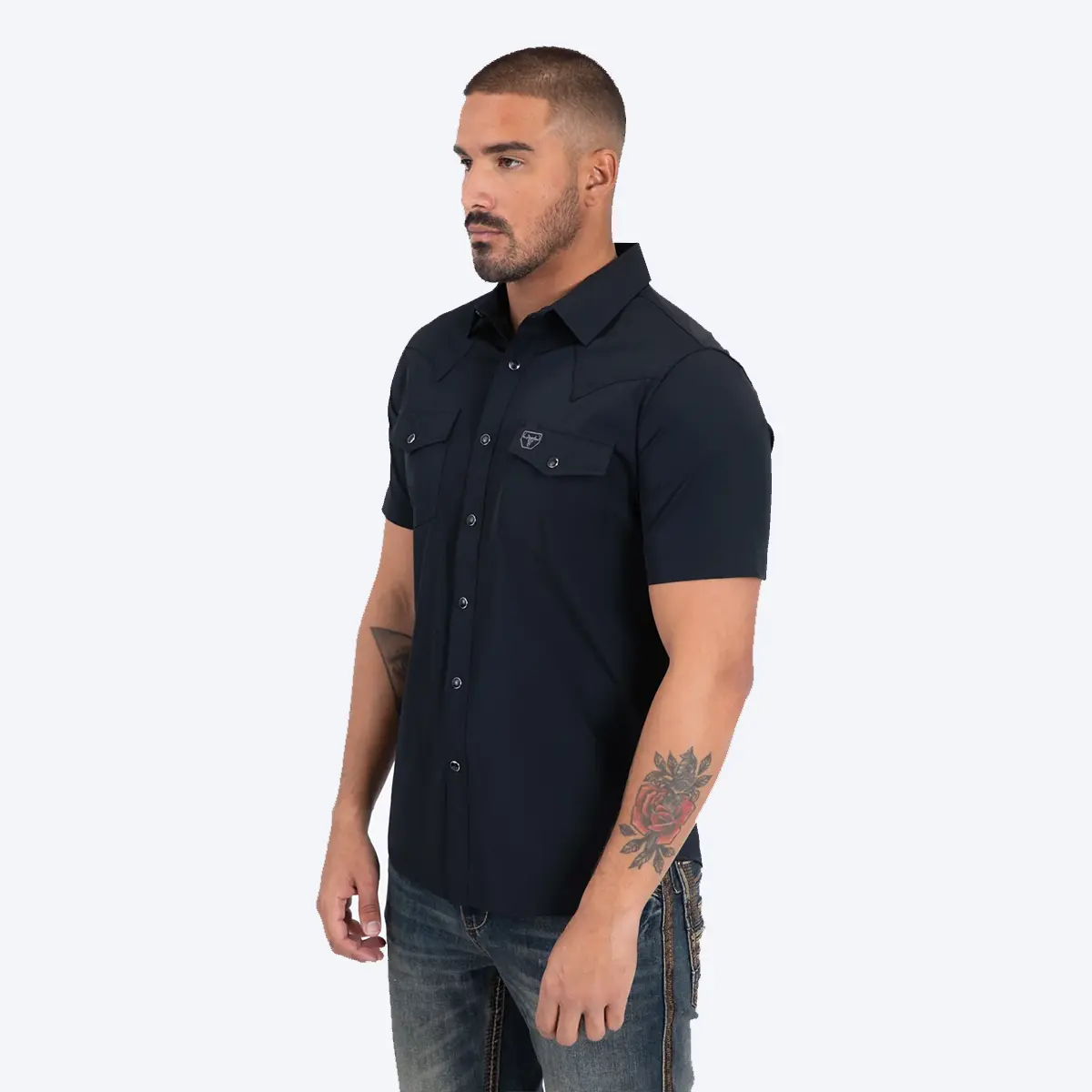 Three-quarter side view of a male model wearing the Platini Prewitt black short sleeve Western performance shirt.