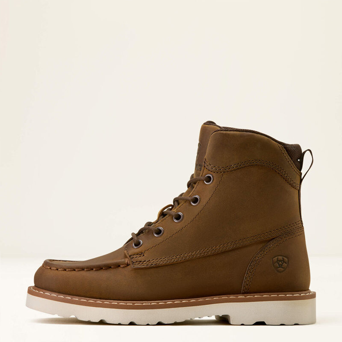 Side profile of kids Ariat brown leather boot on a beige background.