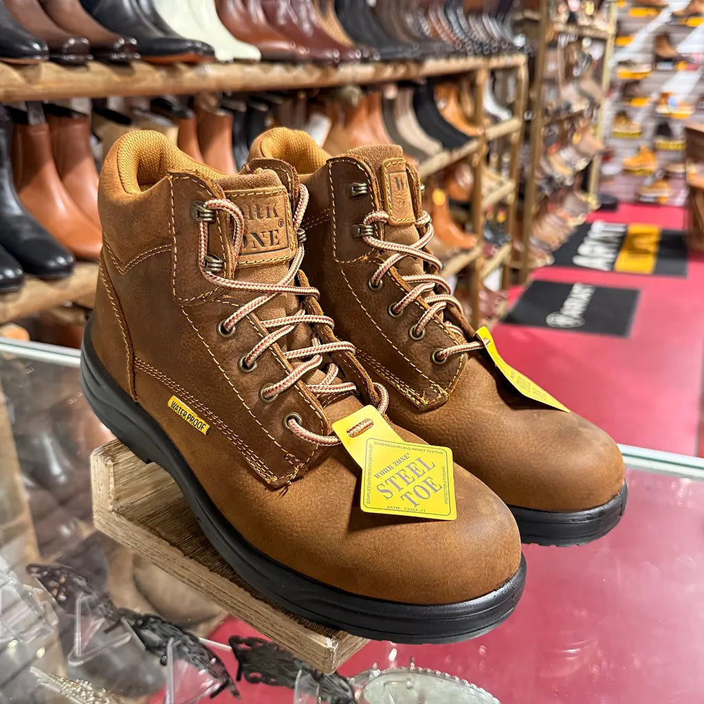 In-store display view of the Work Zone S623 steel toe work boots with official yellow "Steel Toe" hangtags attached.