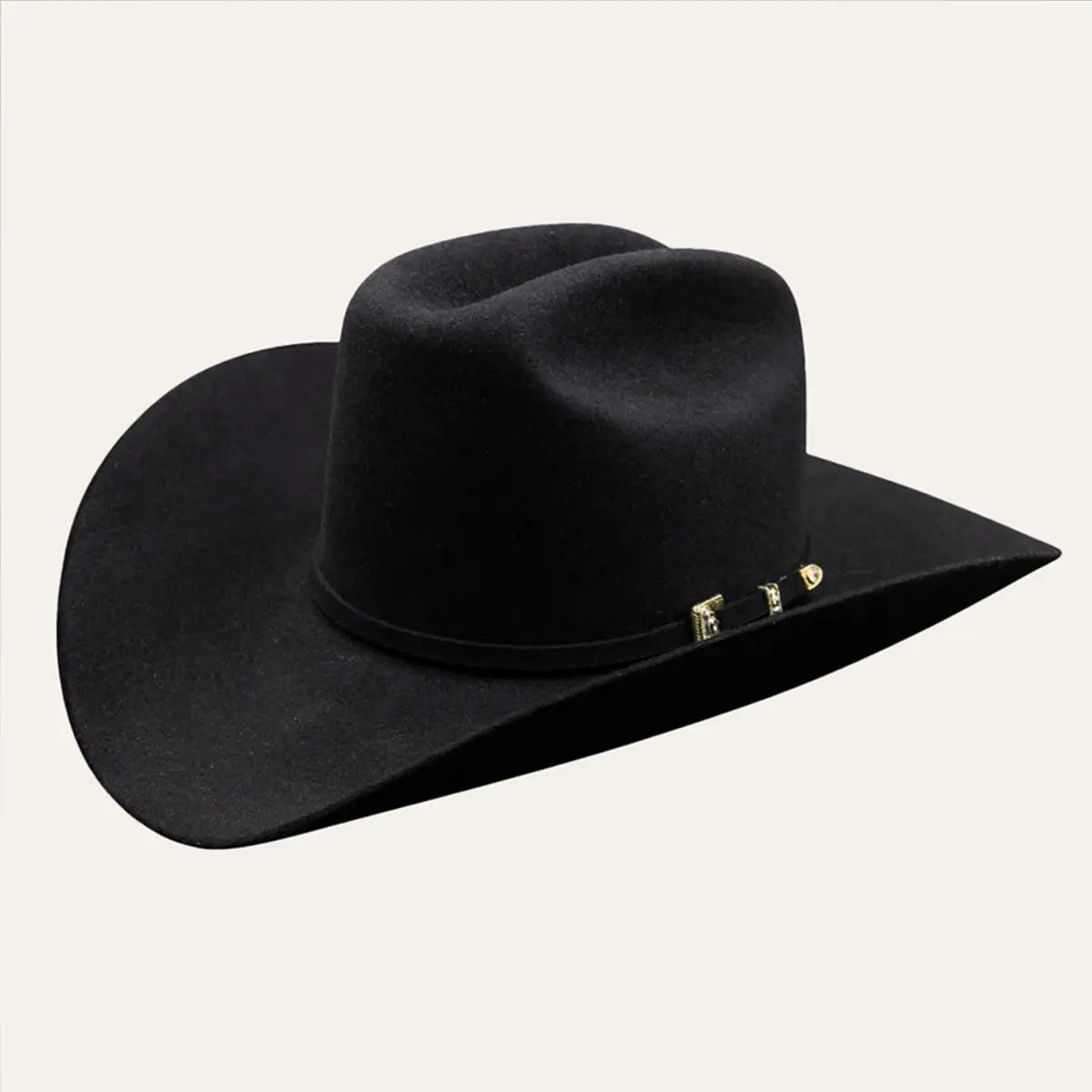 Studio three-quarter view of the Stetson 6X Guadalupana black fur felt cowboy hat on a light background displaying the 4 1/2-inch crown, 4-inch brim, and gold buckle set.
